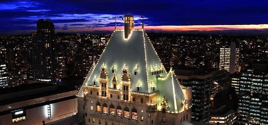 City views and illuminated heritage architecture seen from building rooftop