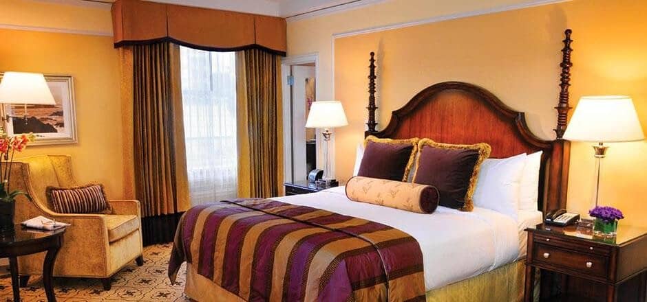 Guest bedroom with king bed and armchair seating area