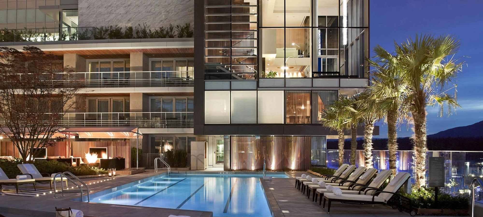 Outdoor lap pool with lounge seating and poolside fire pit