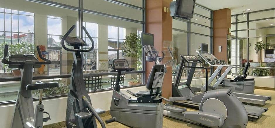 Fitness center with Life Fitness cardio equipment and pool views