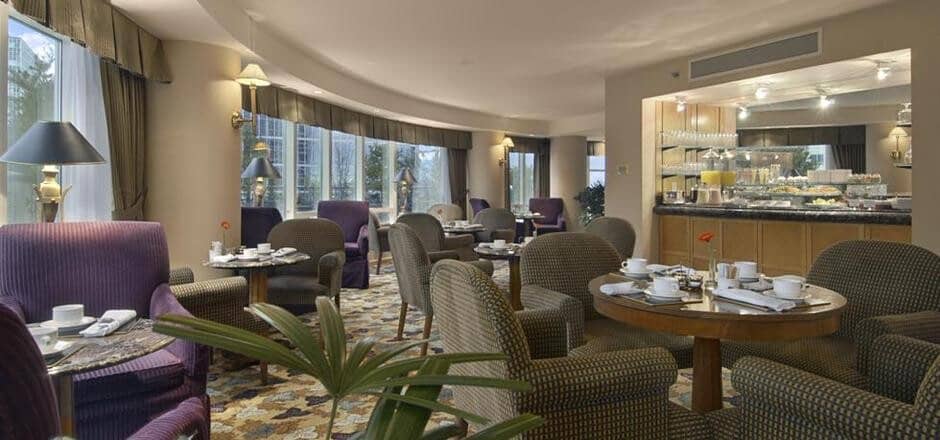Breakfast lounge with floor-to-ceiling windows and buffet service