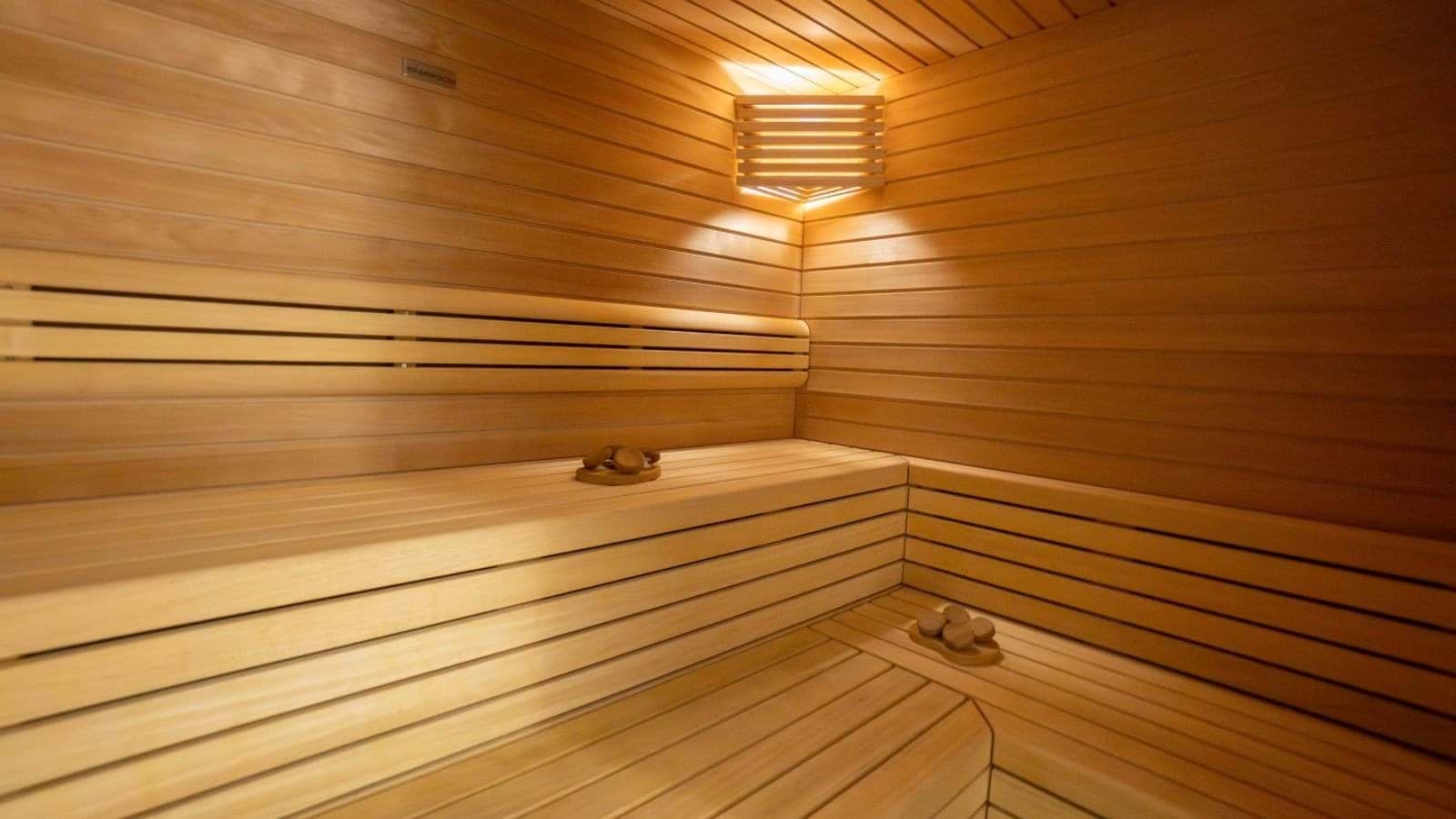 Private cedar sauna with tiered bench seating for four