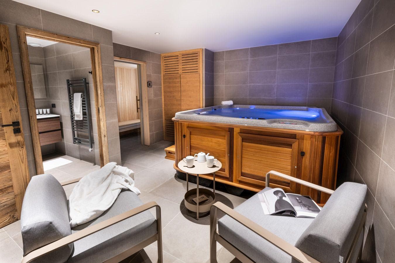Indoor spa with hot tub and adjacent private sauna