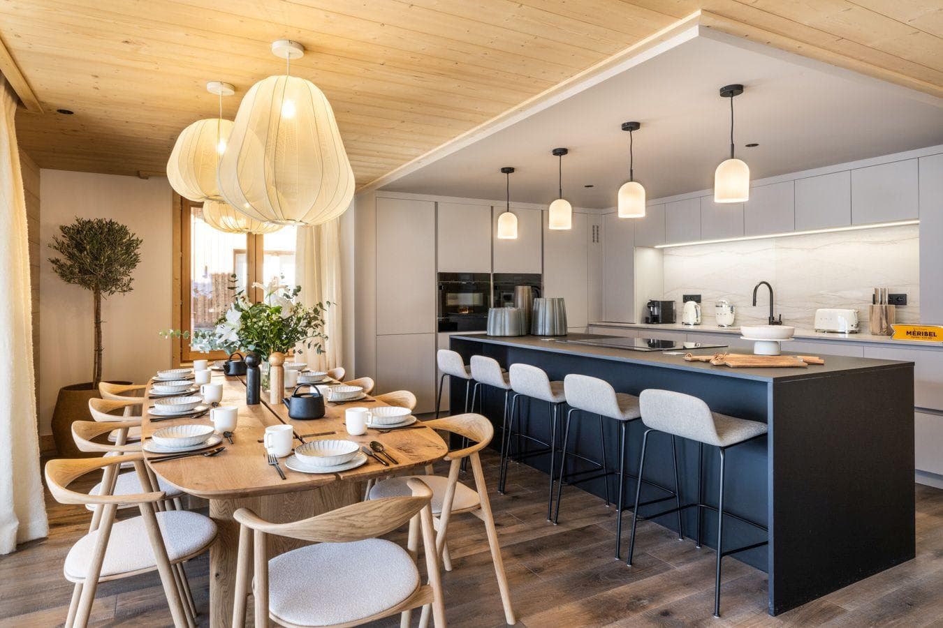 Open-plan dining and kitchen with island seating for 5 and 10-person table