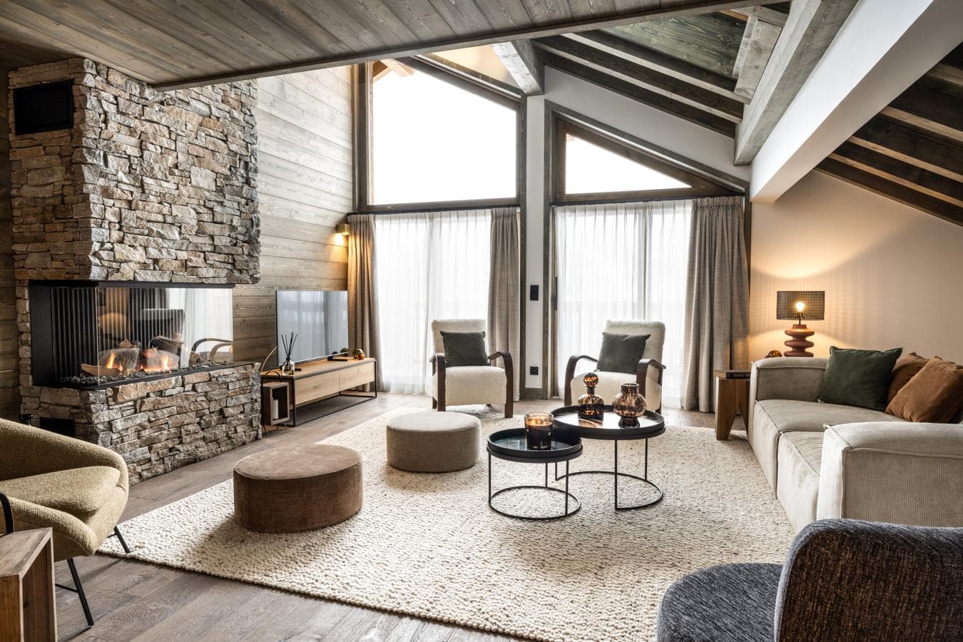 Living area with floor-to-ceiling stone fireplace and three-sided gas hearth