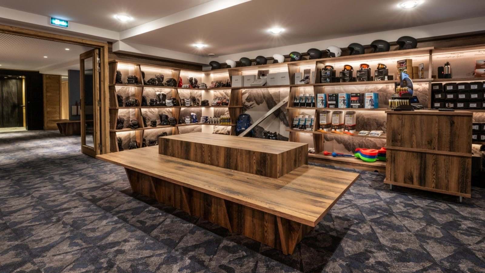 Ski equipment room with gear storage, helmets, and bench for boot fitting