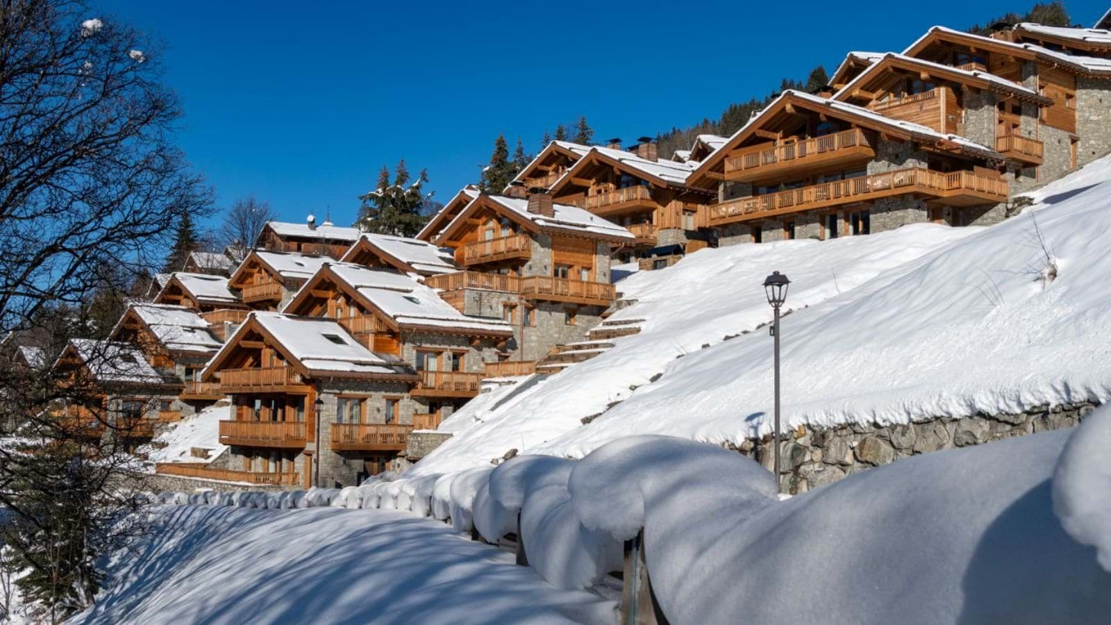 Ski-in, ski-out chalets with private balconies and stone-and-timber facades