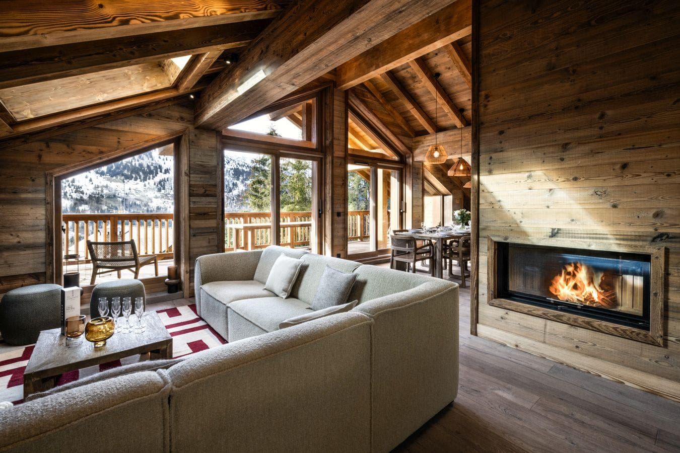 Open living area with wood-burning fireplace and mountain-view balcony