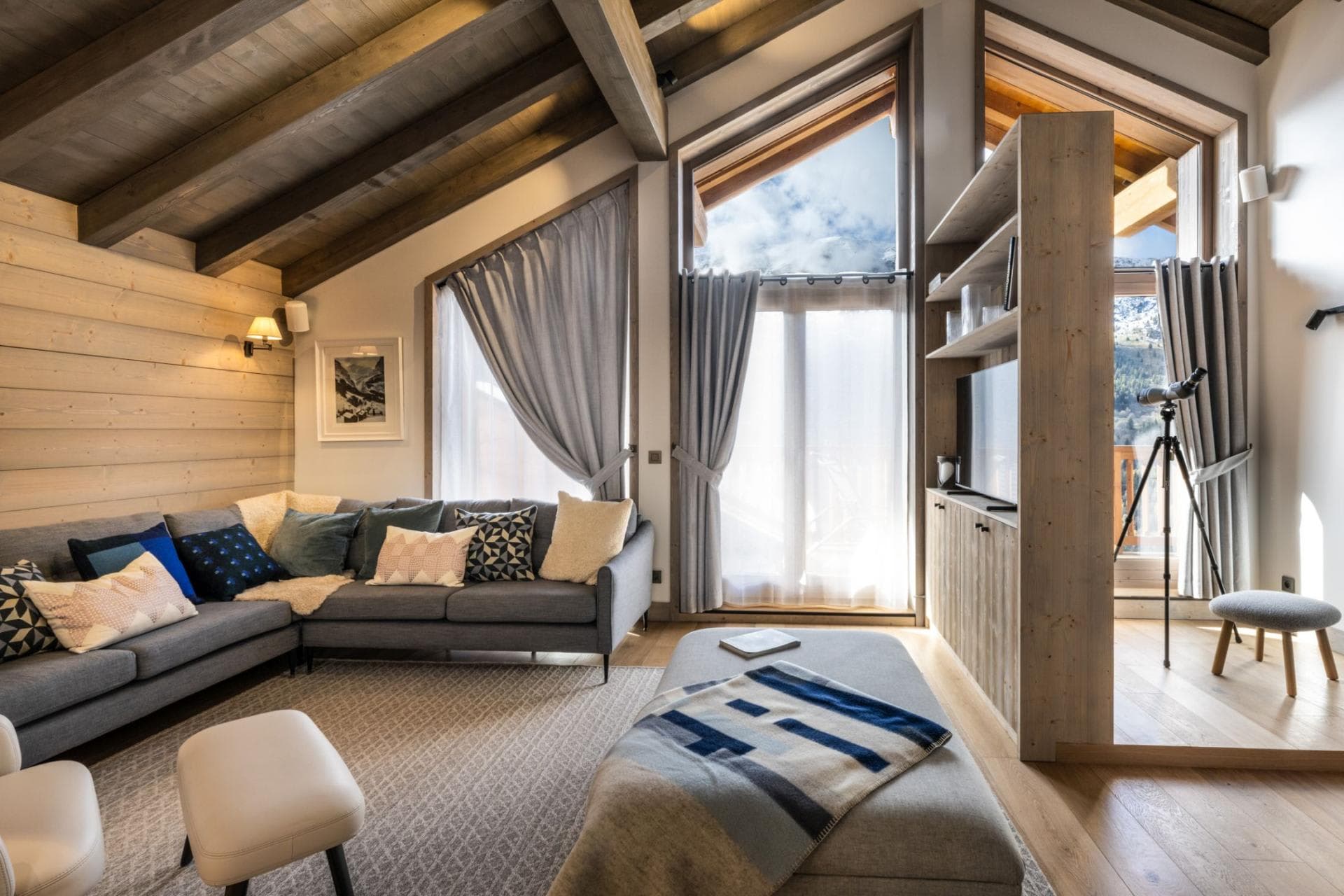 Living area with vaulted wood ceilings and mountain-view telescope