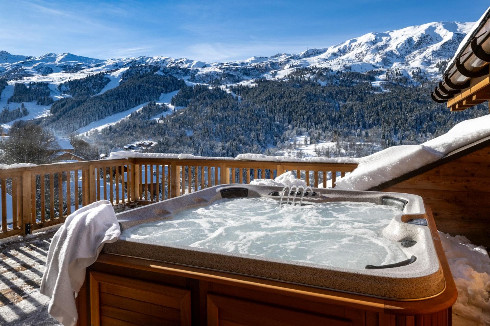 Outdoor hot tub on deck with views of mountain ski runs