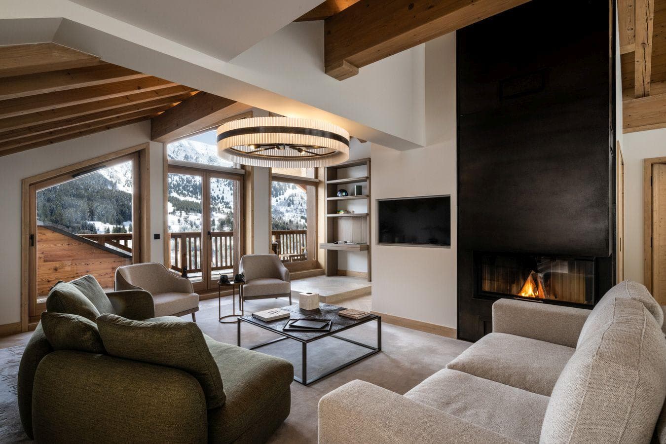 Living area with wood-burning fireplace and mountain-view balcony access