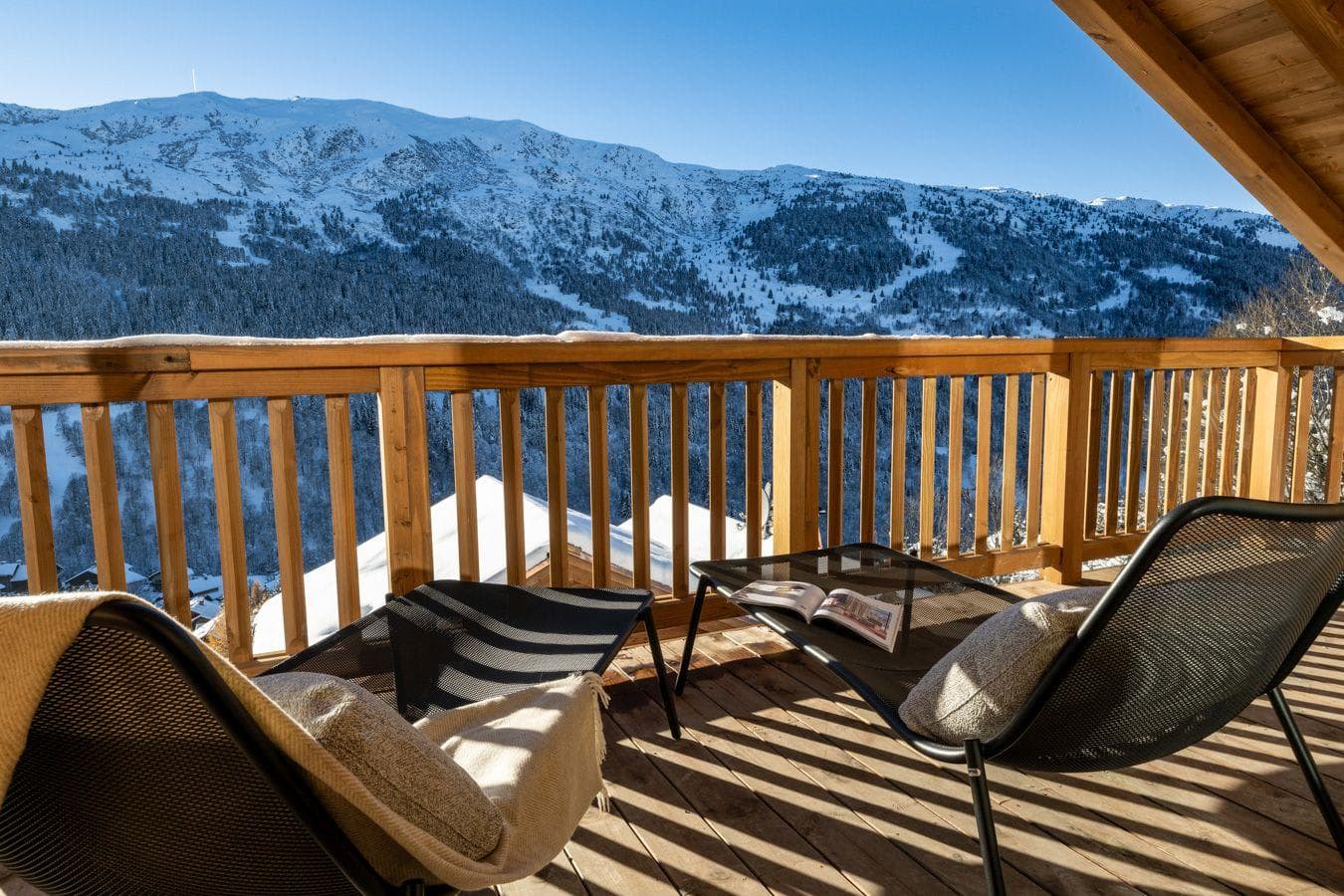 Private balcony with lounge seating and panoramic mountain views