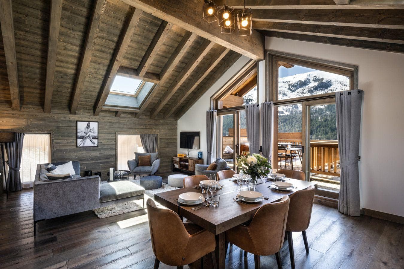 Open living area with vaulted wood ceilings and mountain views