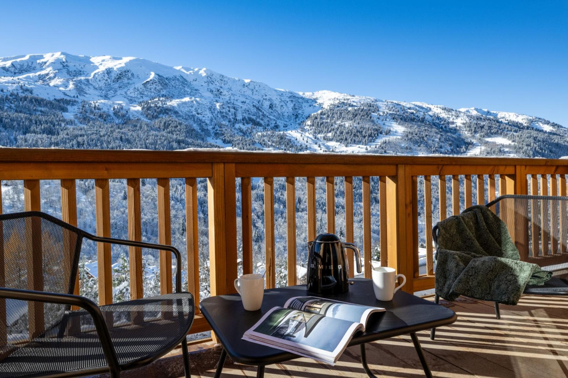 Private balcony with seating and panoramic alpine mountain views