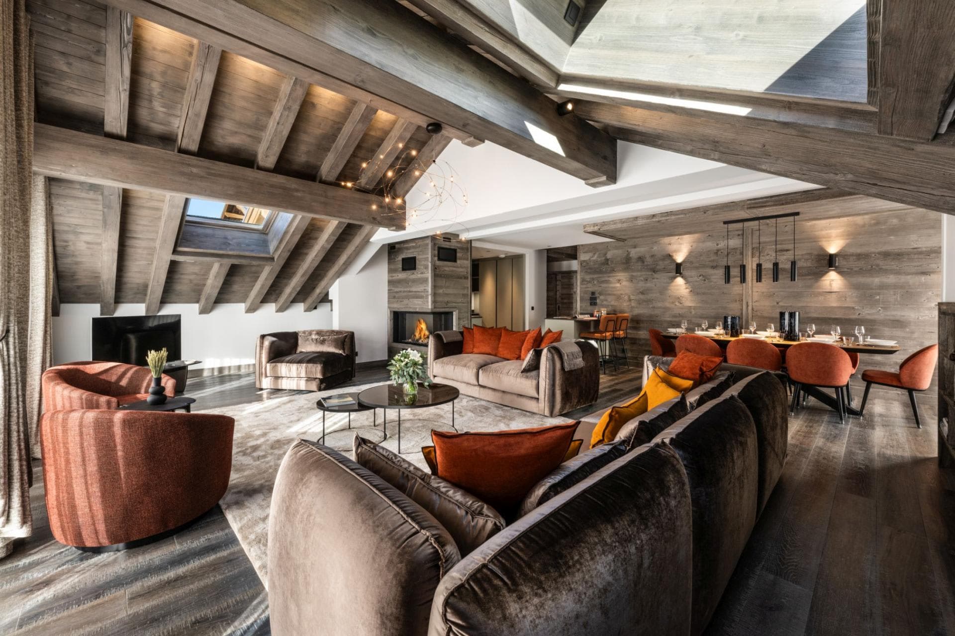 Open-plan living area with wood-burning fireplace and dining for 8