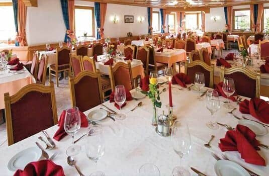 Large dining room with set tables and seating for 40+ guests