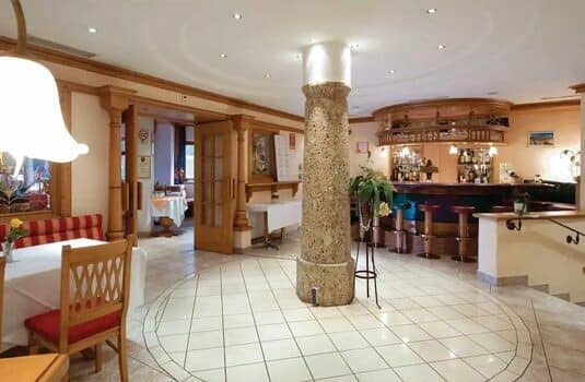 Shared lounge area with full-service bar and booth seating