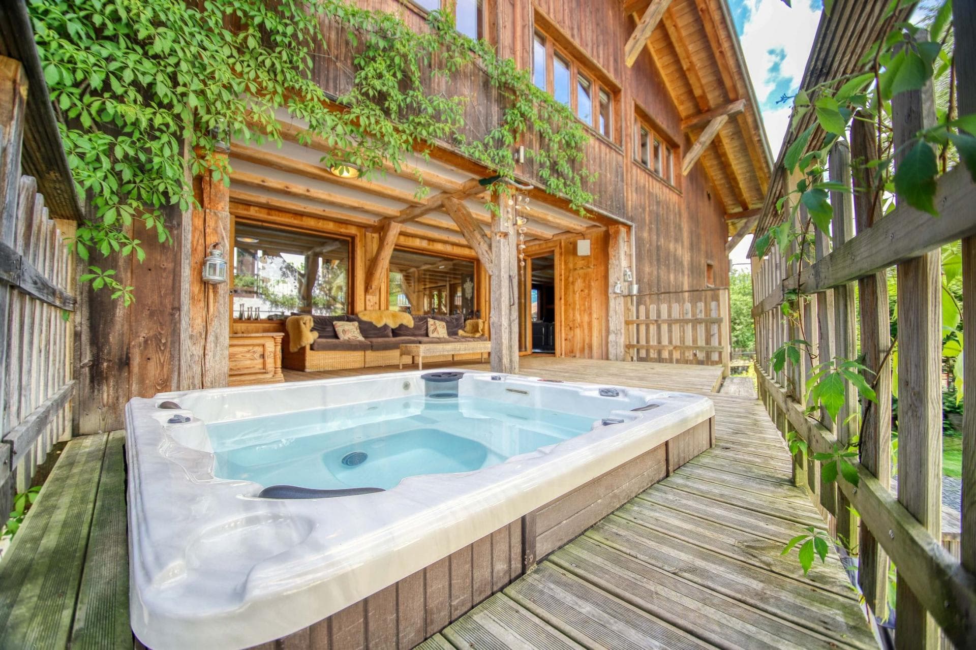 Hot tub on private deck with adjacent covered seating area