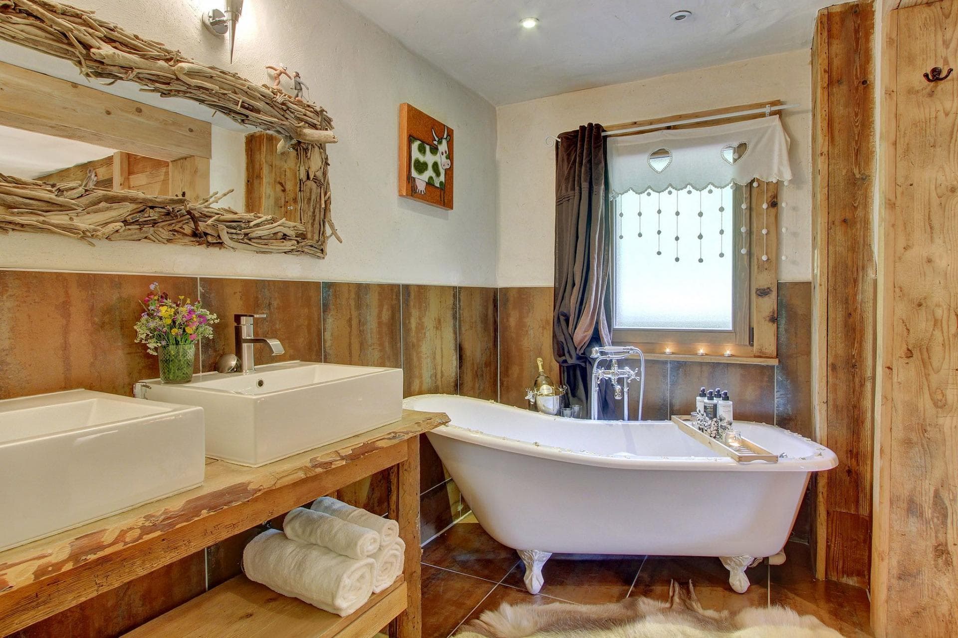 Bathroom with clawfoot soaking tub and dual vessel sinks