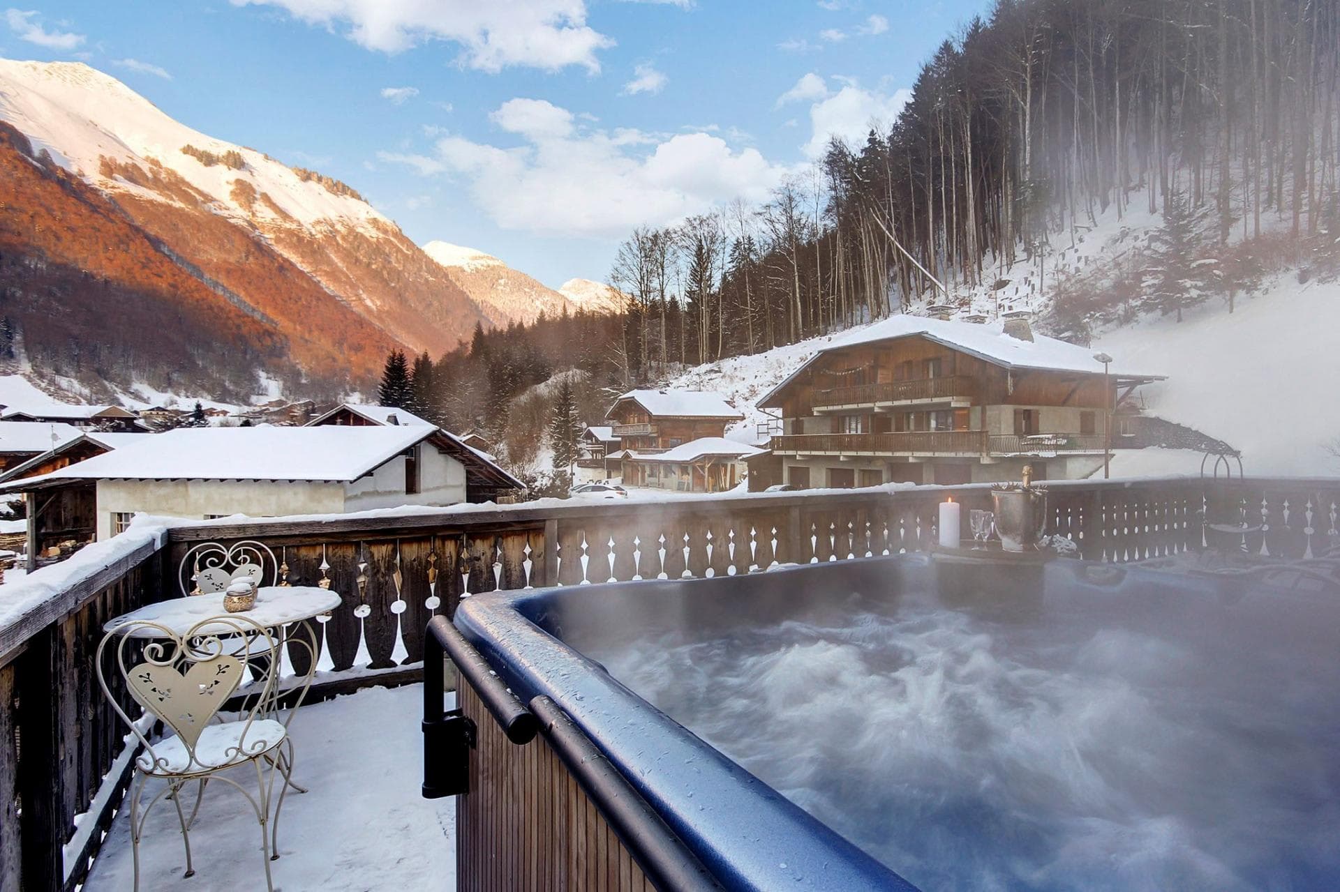 Outdoor hot tub on balcony with panoramic mountain views