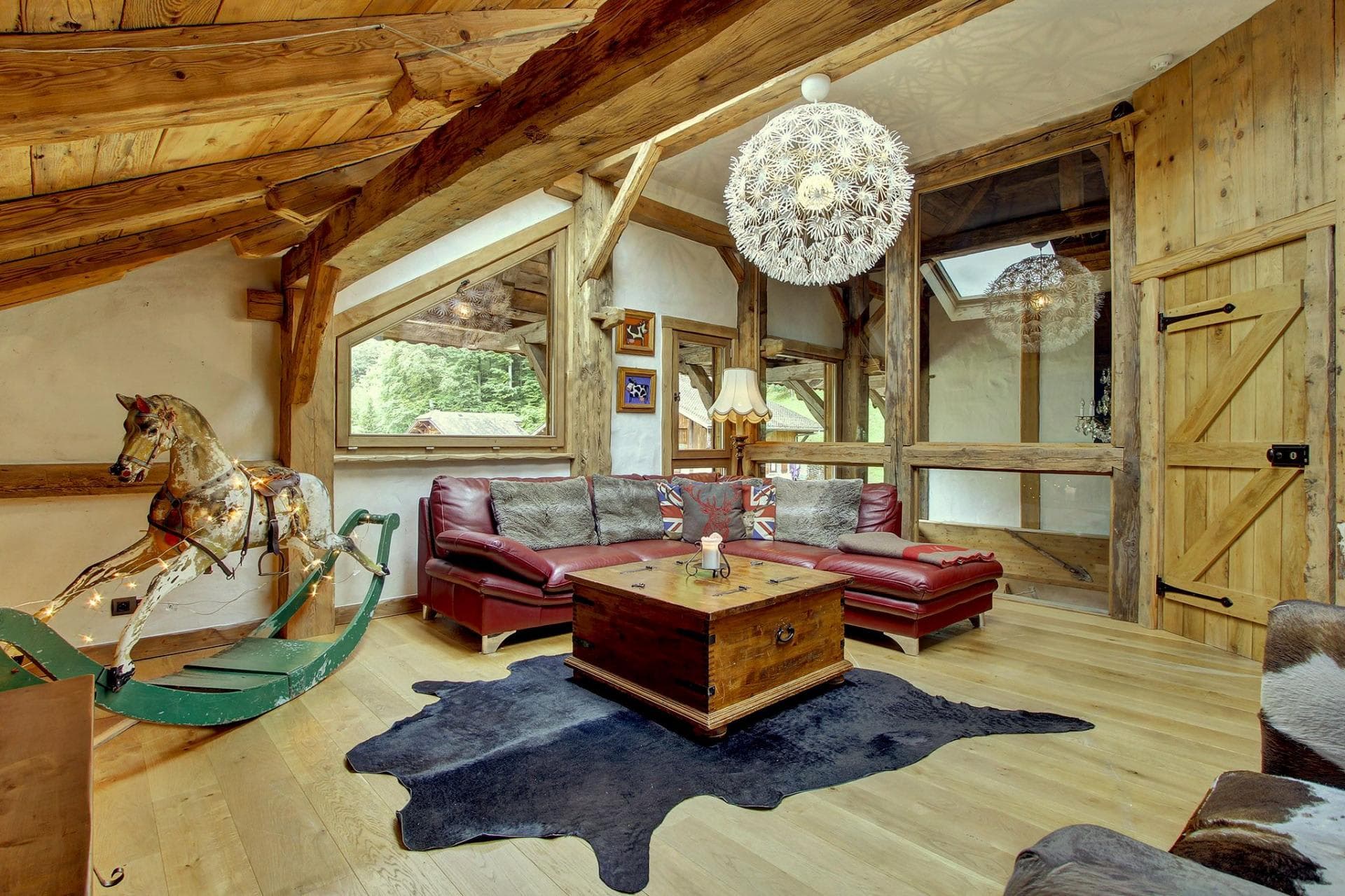 Living area with vaulted timber ceilings and leather sectional seating