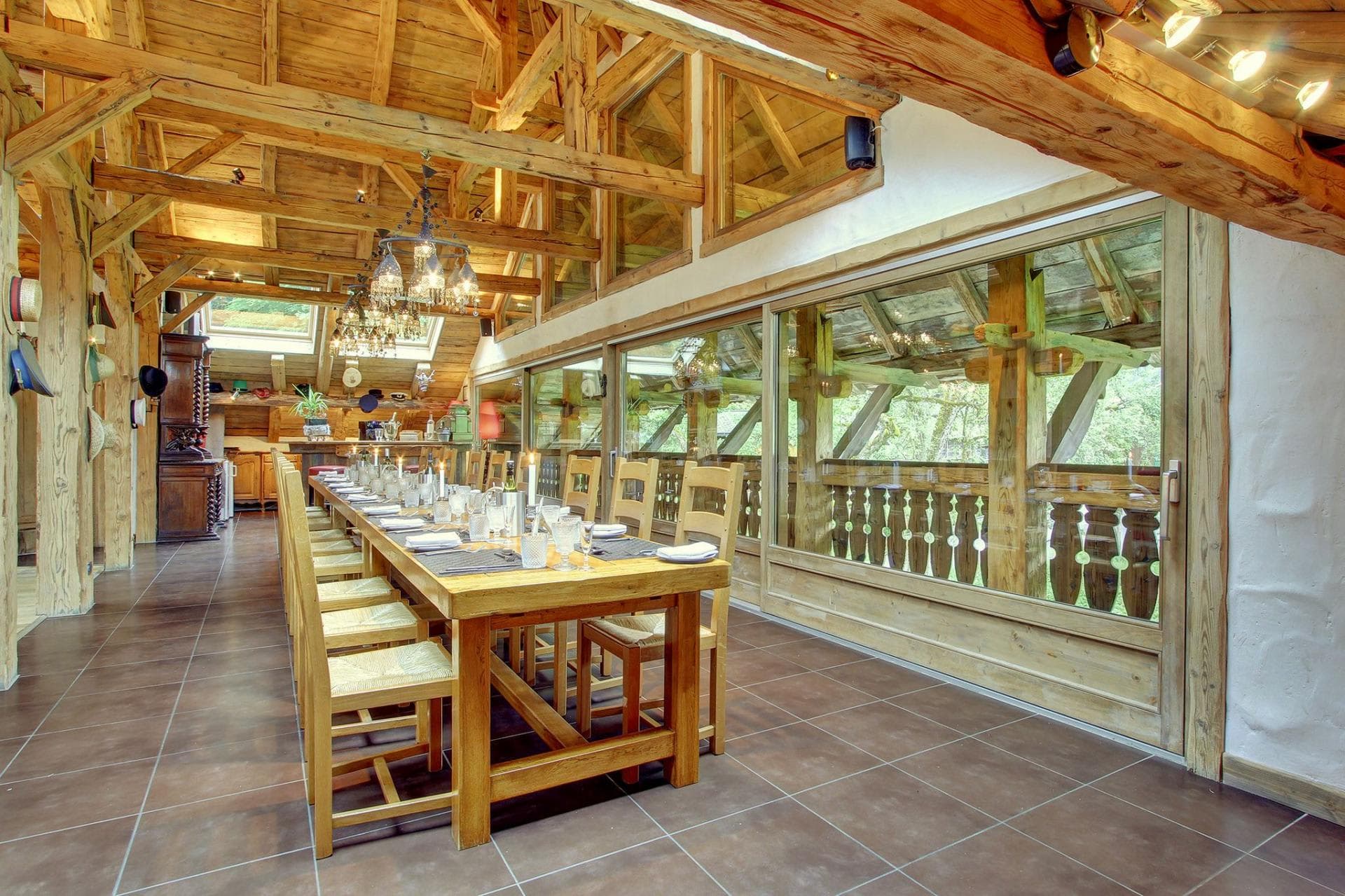 Dining area seats 14; exposed timber beams and floor-to-ceiling windows