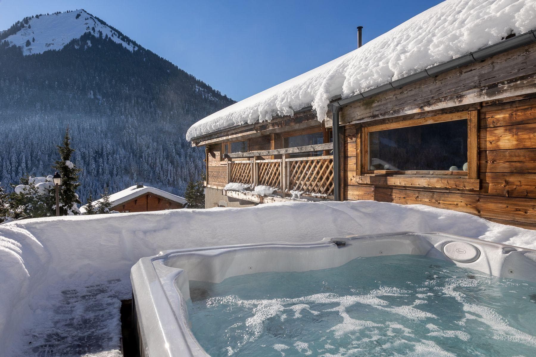 Outdoor hot tub with mountain views and direct chalet access