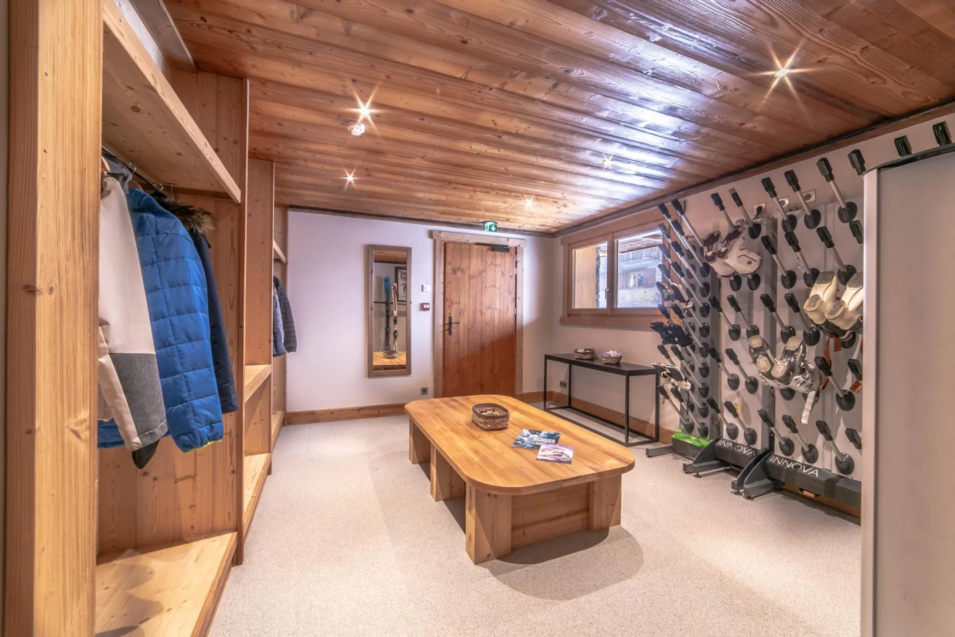 Ski room with wall-mounted boot warmers and equipment storage