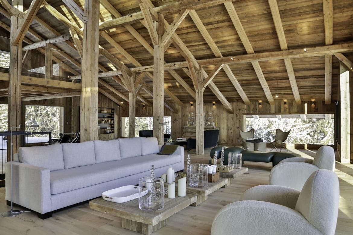 Open-plan living area with vaulted timber beams and seating for 10