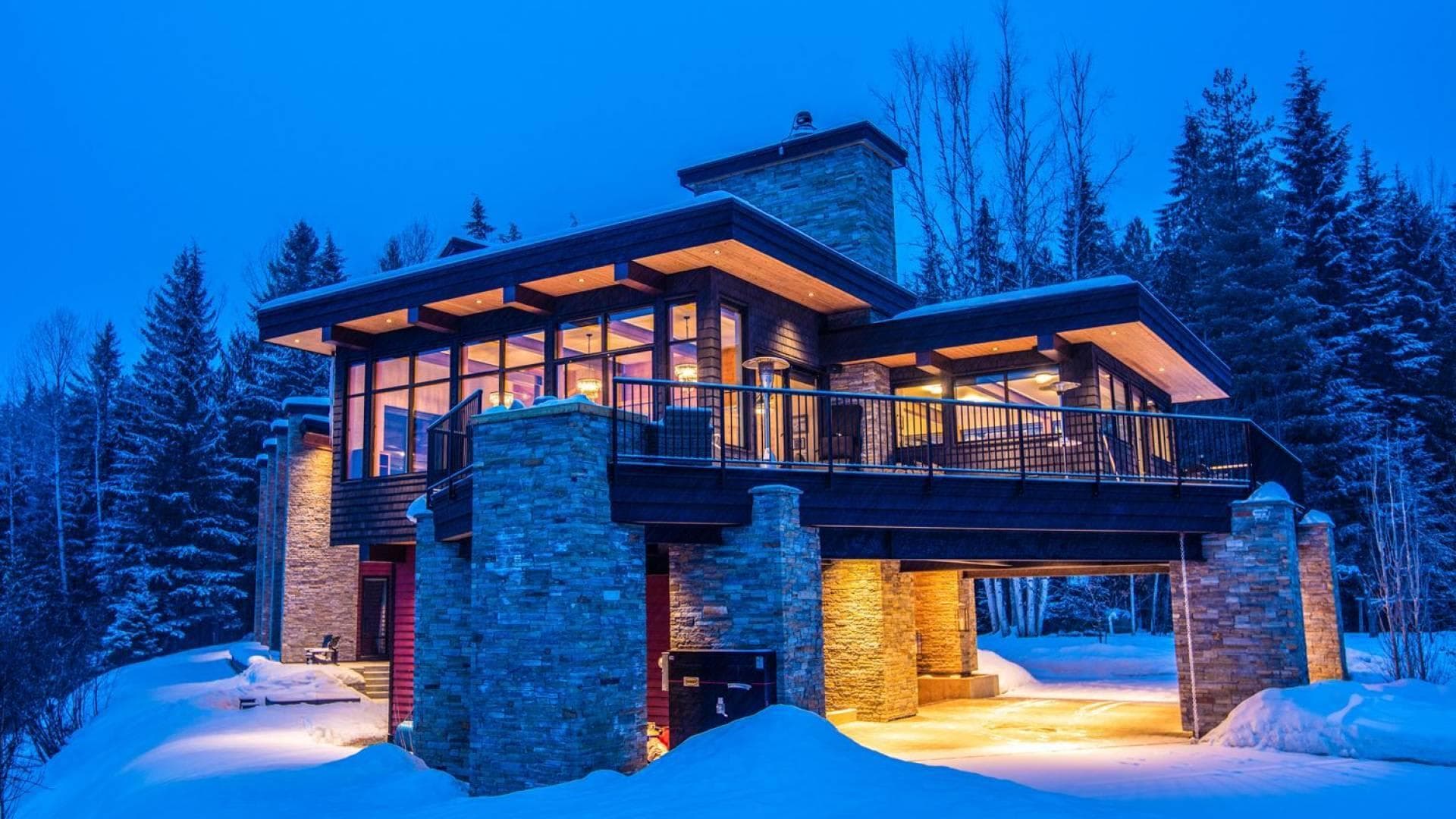 Elevated exterior with wrap-around deck and covered parking area