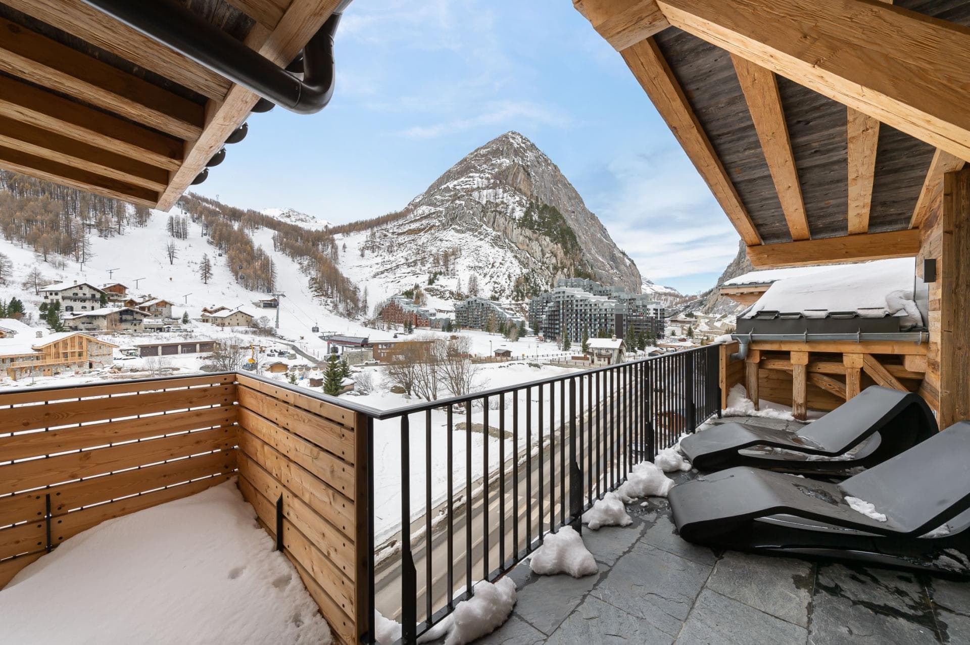 Covered balcony with lounge seating and ski-in/ski-out resort views