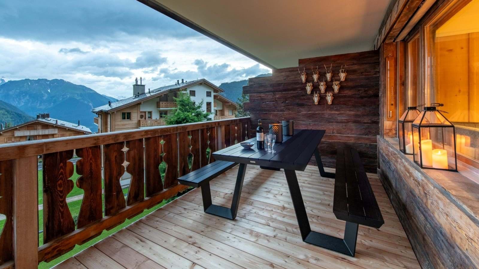 Covered balcony with picnic table seating and mountain valley views