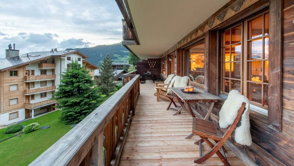 Covered balcony with village views and seating for 4