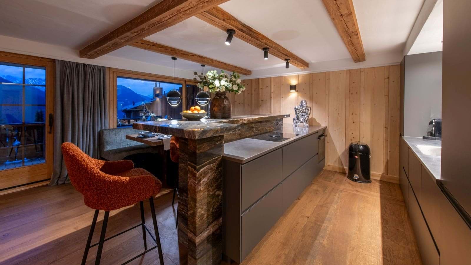 Kitchen island with stone breakfast bar and integrated induction cooktop