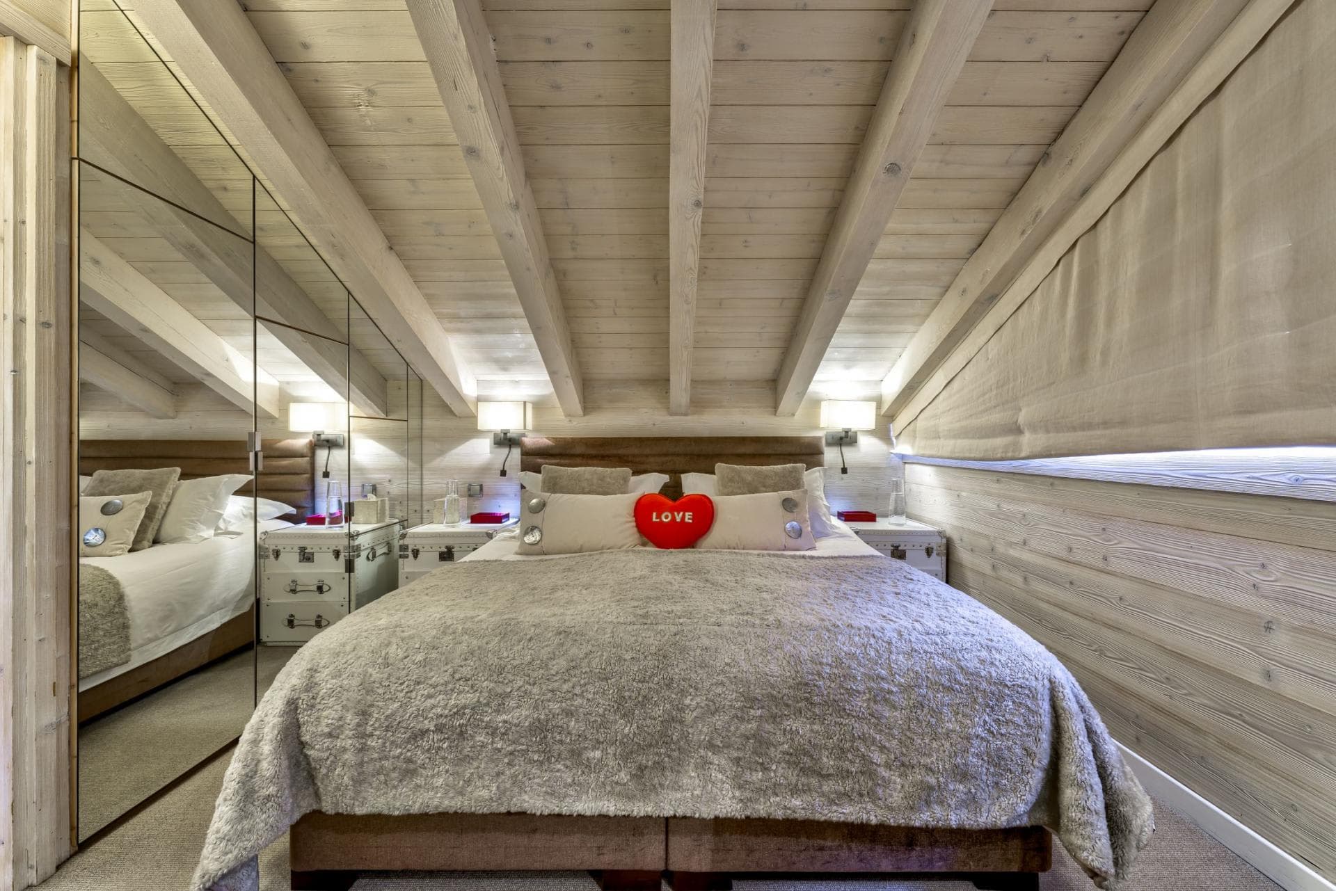 Attic bedroom with queen bed and floor-to-ceiling mirrored wardrobes