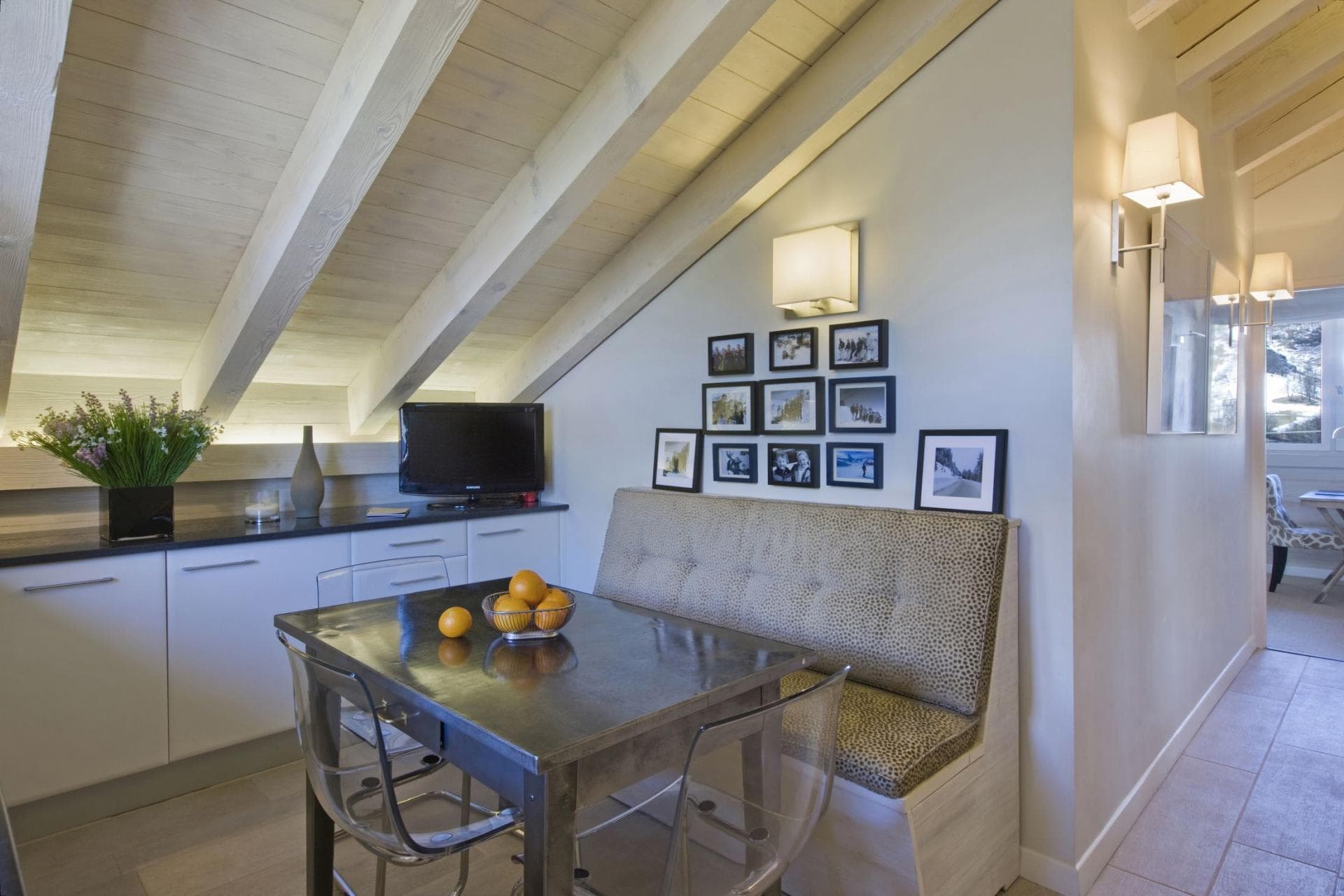 Dining nook with banquette seating and vaulted wood beam ceilings