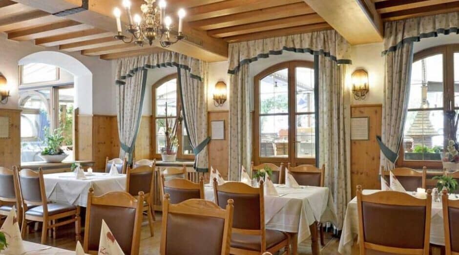 Dining room seats 12; arched windows overlook street, exposed beam ceiling