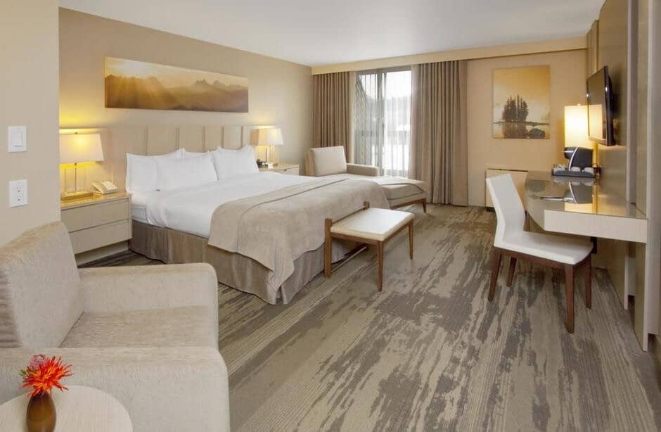 Guest suite with king bed, workstation, and seating area