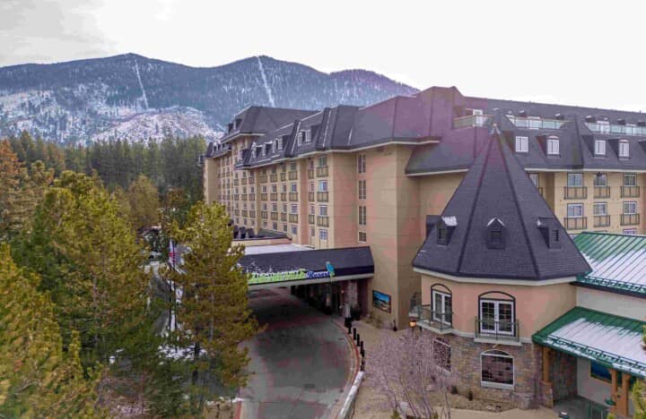 Resort exterior with covered porte-cochère and mountain views