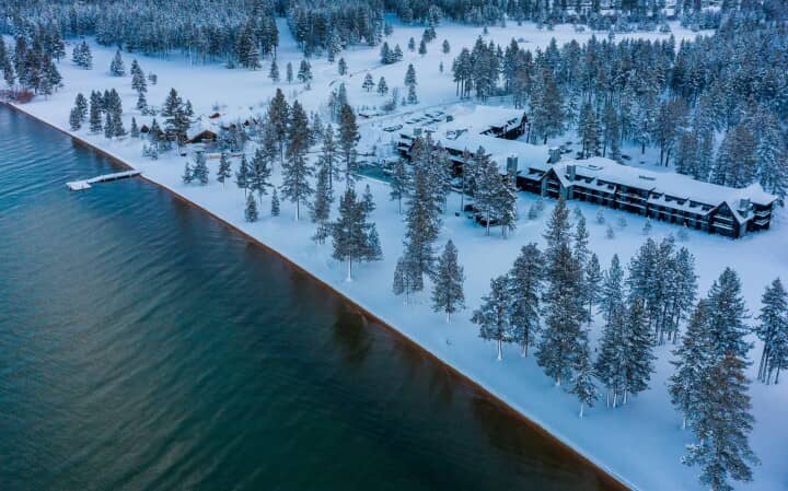 Aerial view of lakefront lodge with private beach and boat dock