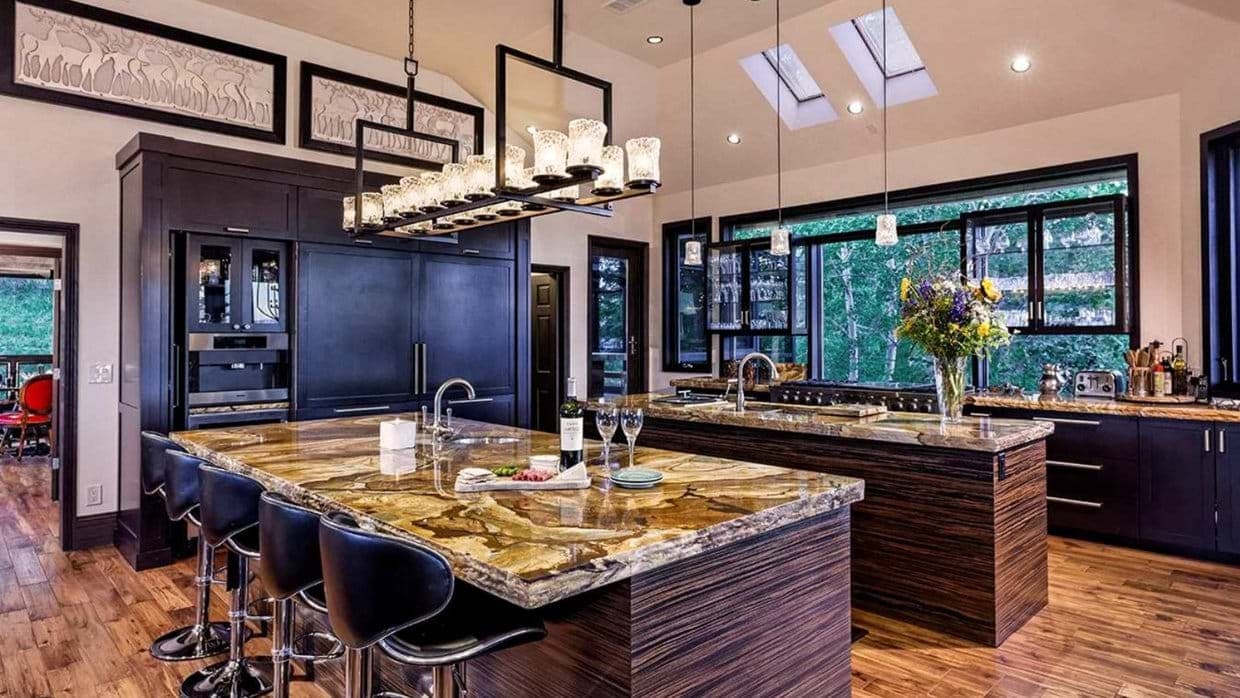 Kitchen with dual islands and skylights; bar seating for four