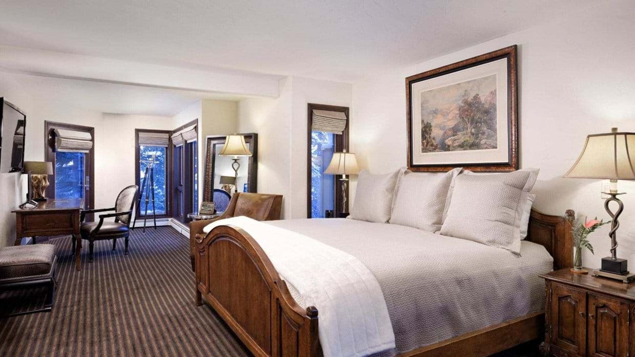 Bedroom with king bed, work desk, and balcony access