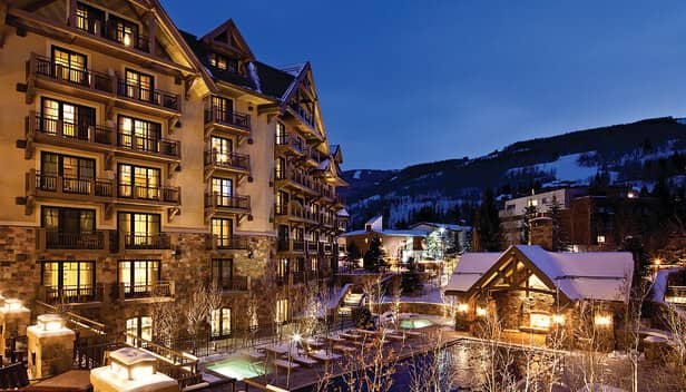 Resort exterior with heated outdoor pool and ski slope views