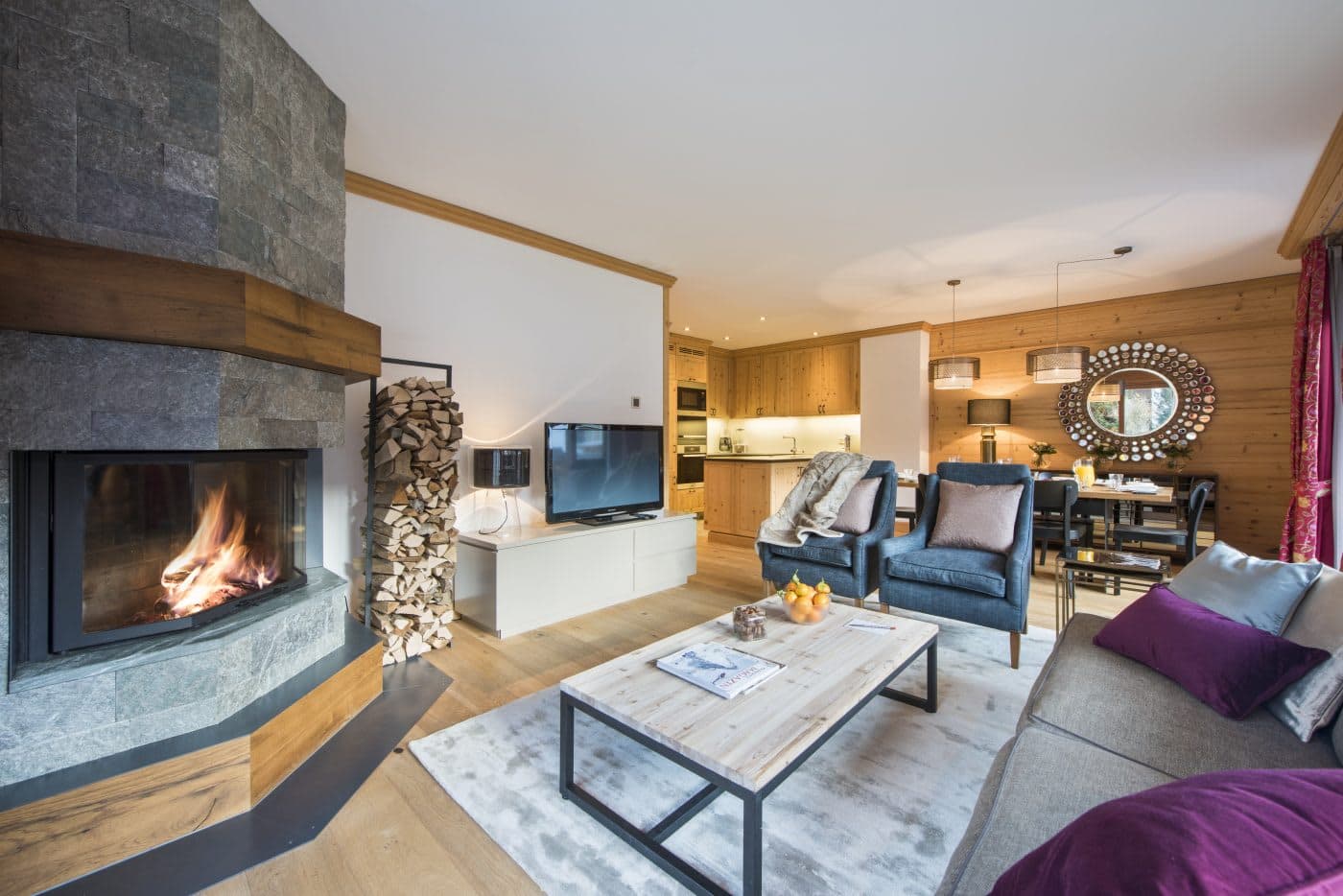 Open-plan living area with wood-burning fireplace; dining table seats 6