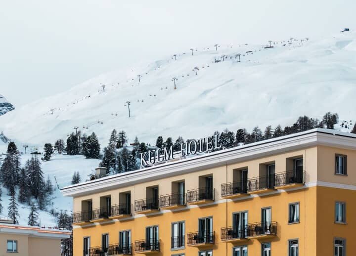 Hotel exterior with private balconies and direct ski lift access behind