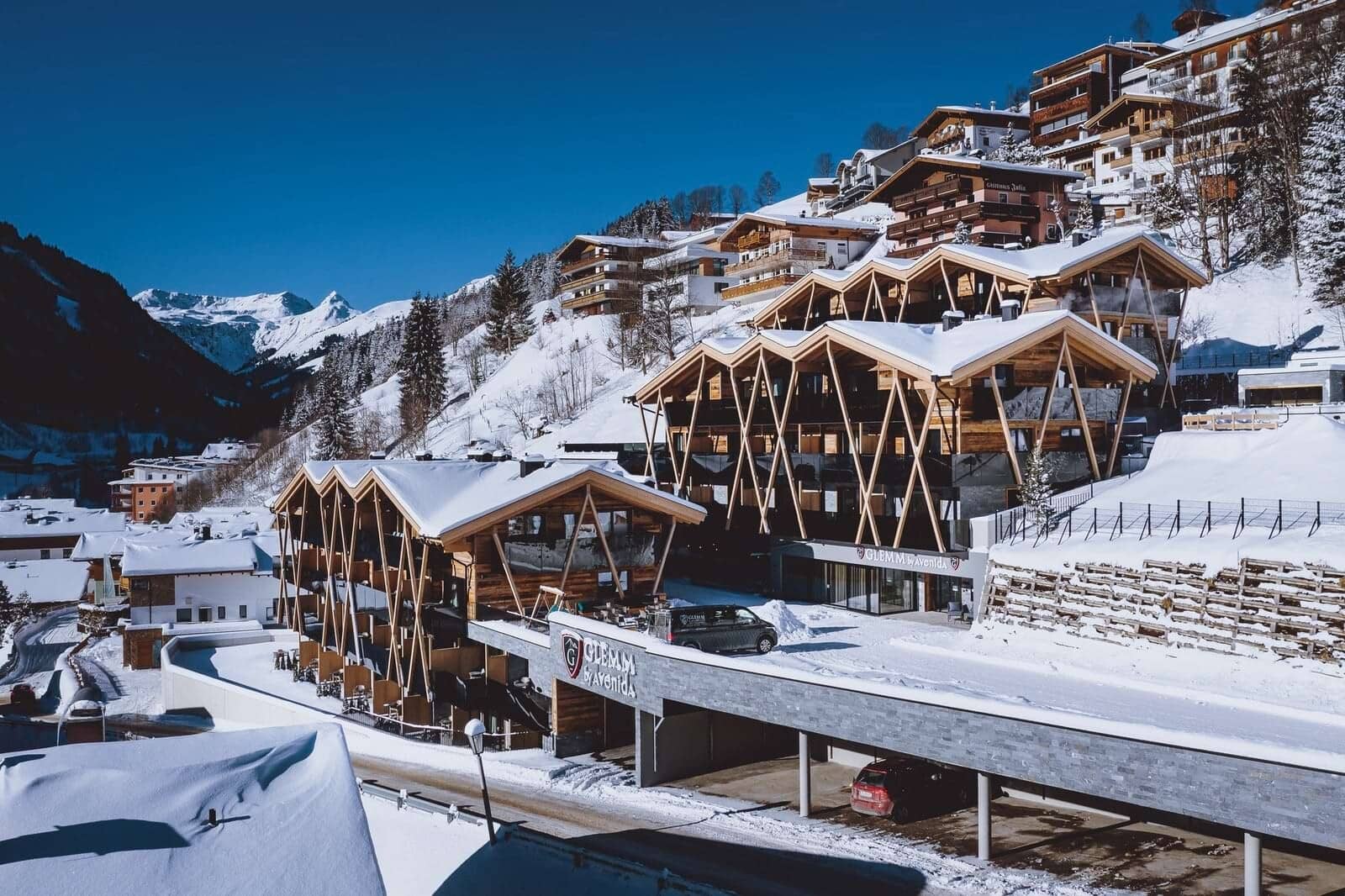 Ski-in/ski-out resort exterior with covered parking and alpine valley views