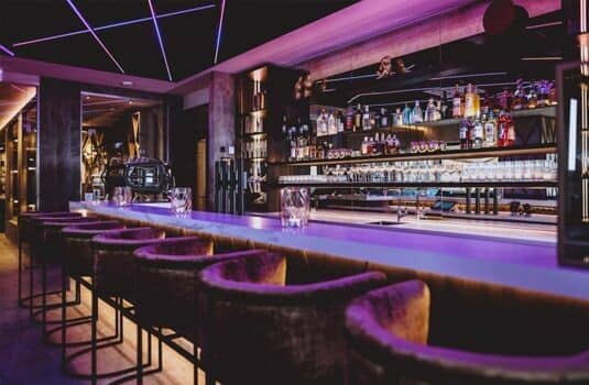 Private cocktail bar with marble counter and seating for six