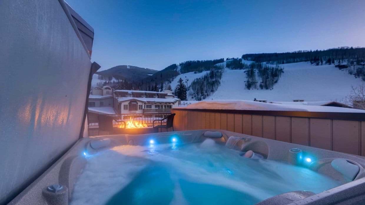 Private outdoor hot tub and fire pit with ski slope views