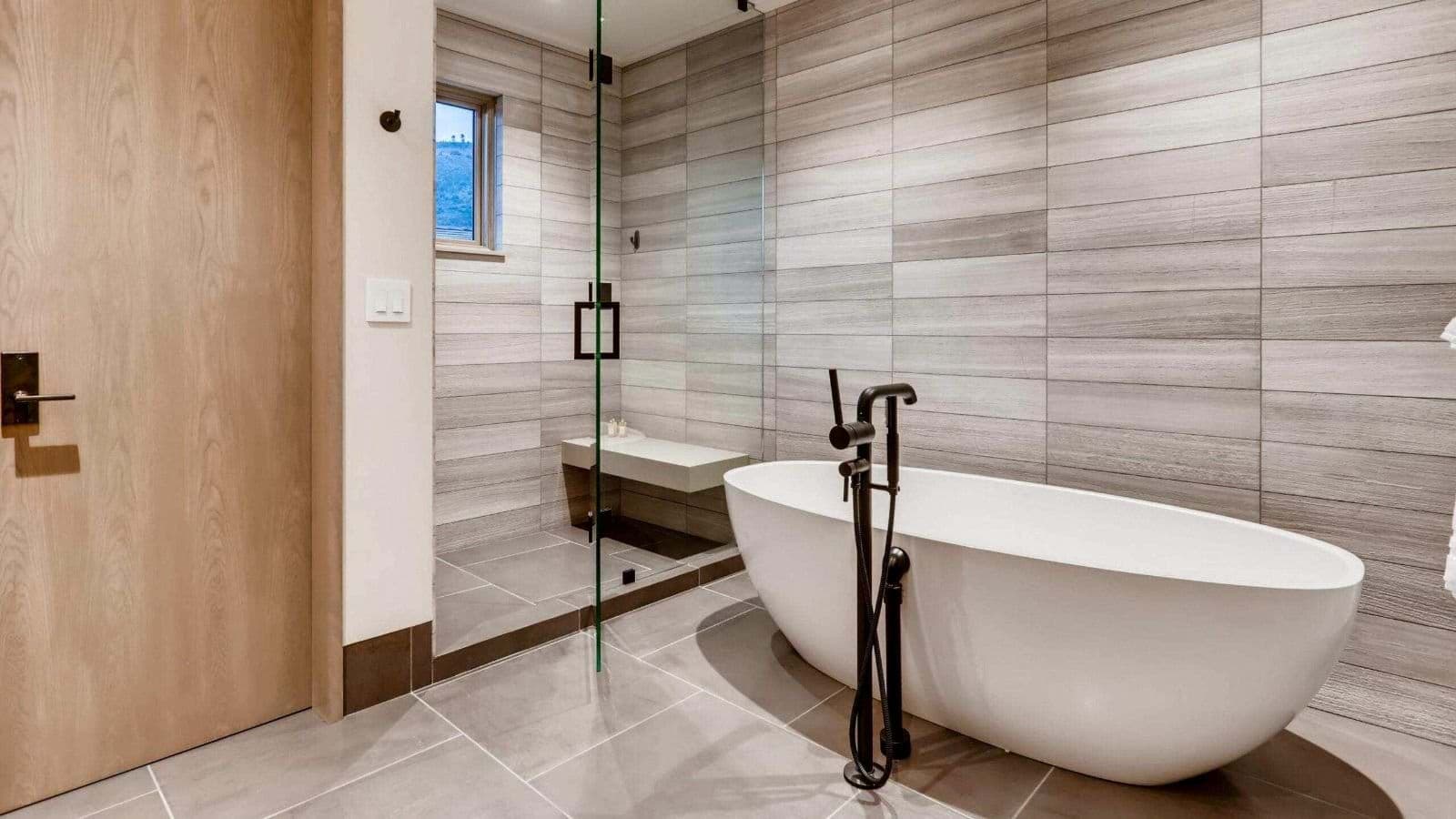 Bathroom with soaking tub and walk-in shower featuring built-in bench