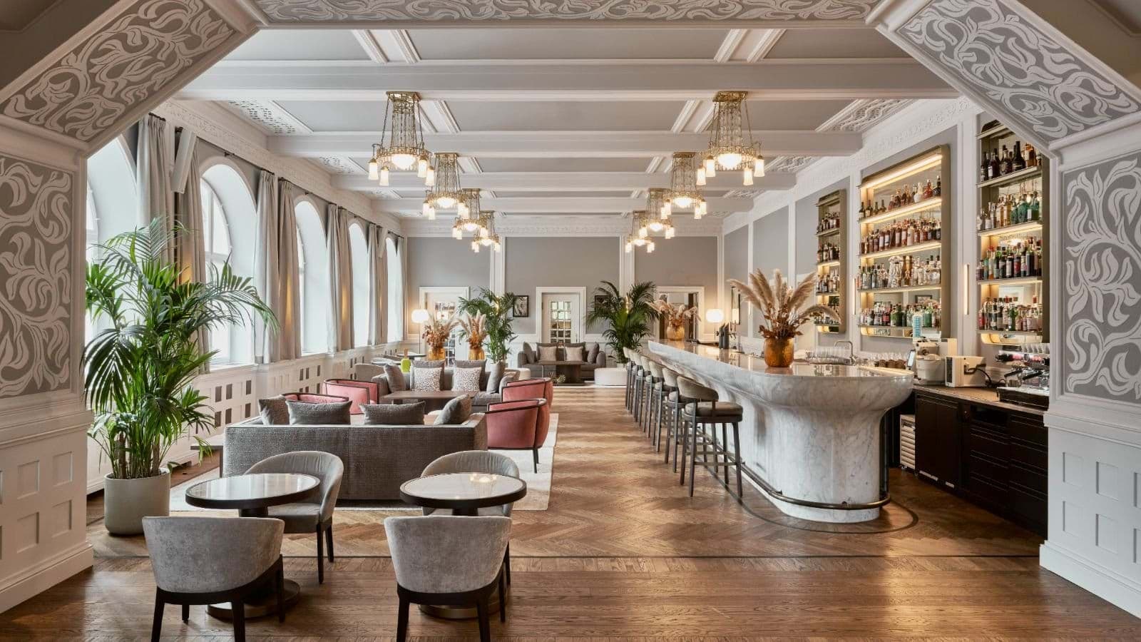 Lounge area and marble-topped bar with seating for 10
